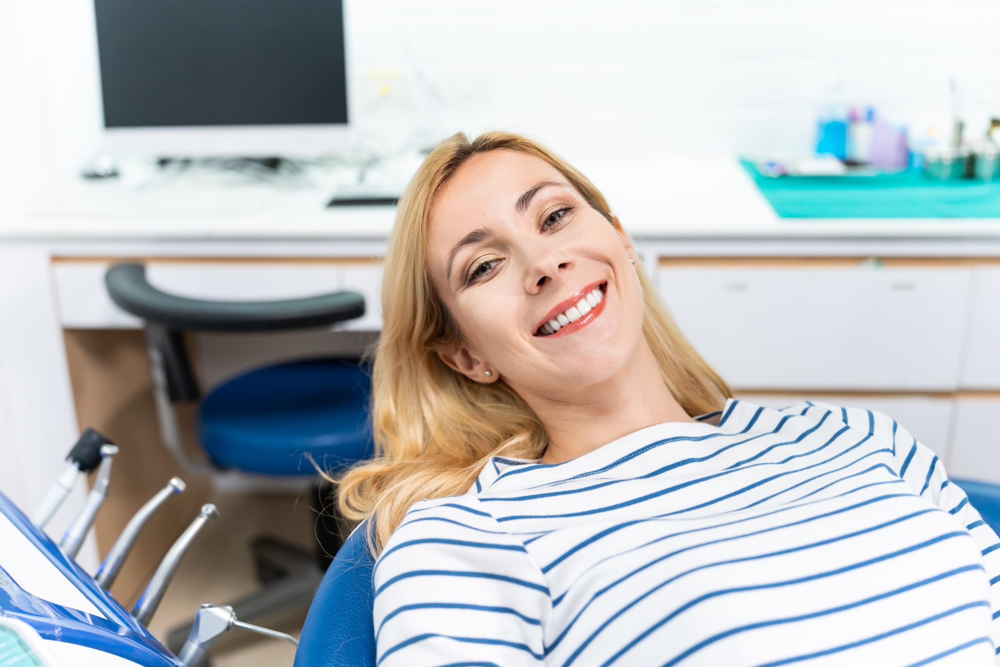 Woman smiling after chiropractic adjustment