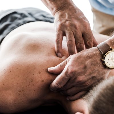 Chiropractor manipulating upper back